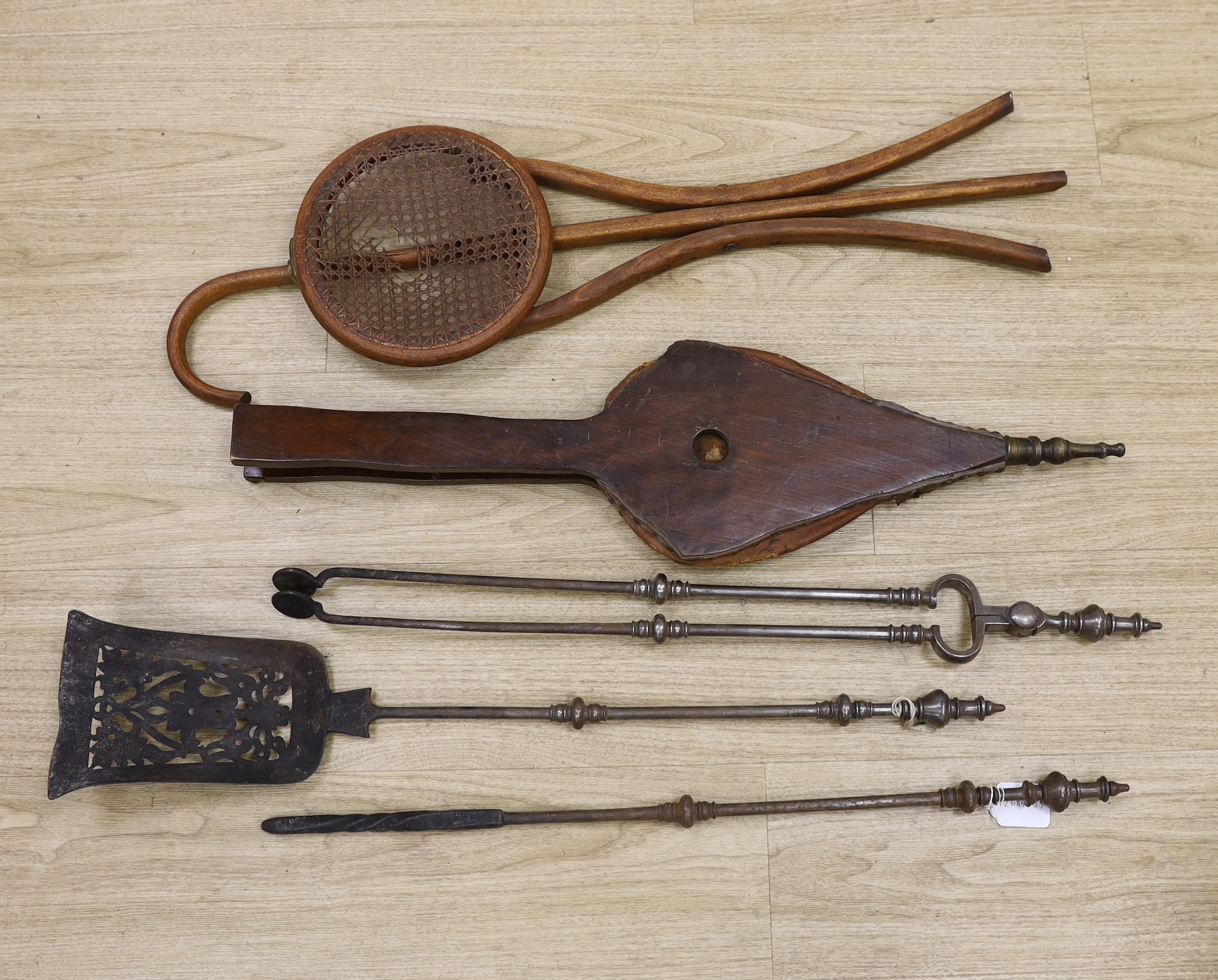 A set of three late Georgian steel fire irons, 79cm in length, together with a bellows and folding seat